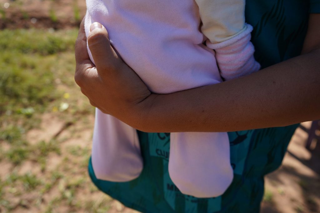 Sany's arm holding her daughter. 