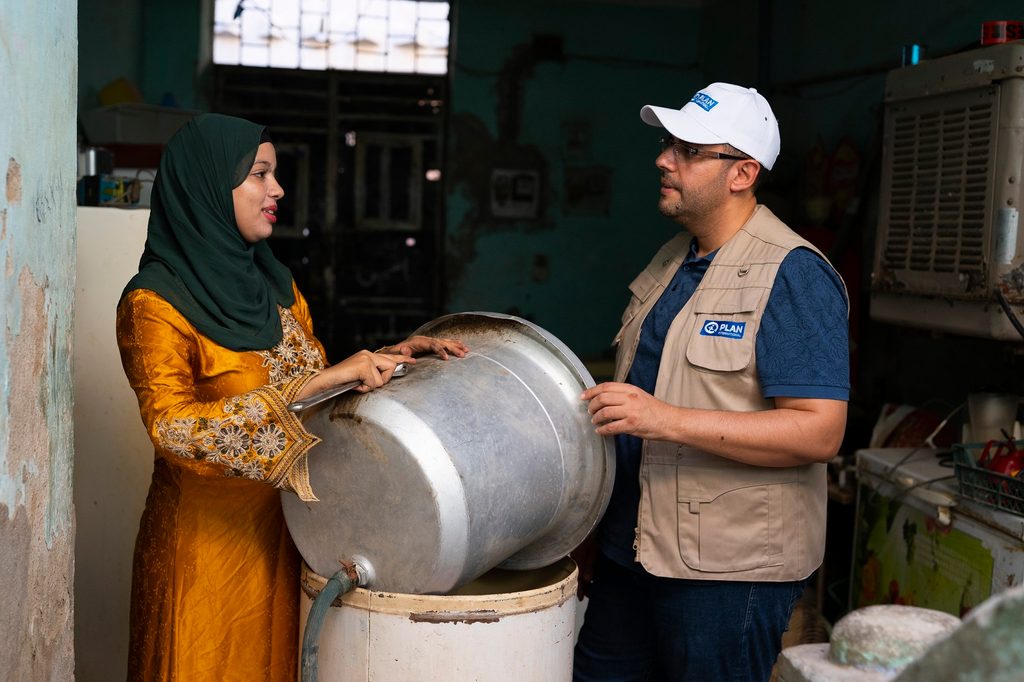 Basma talking with a member of Plan International staff