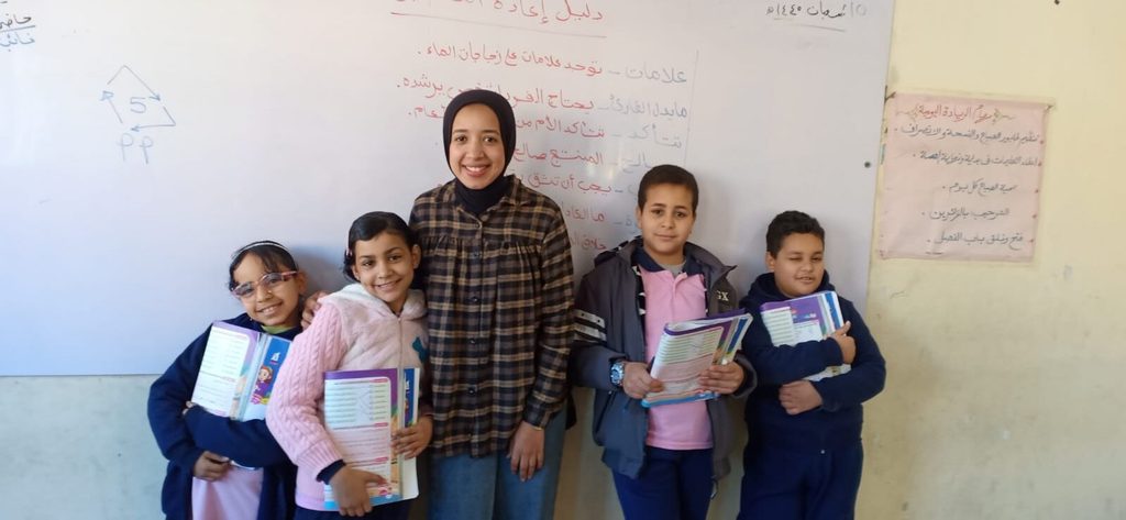 Yassmin stands with 4 of her students.