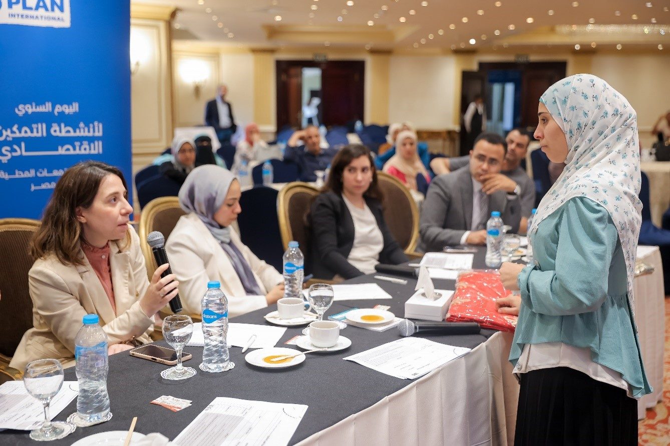 Hala discussing her project with the jury during the annual showcase conference for economic interventions in local communities. 