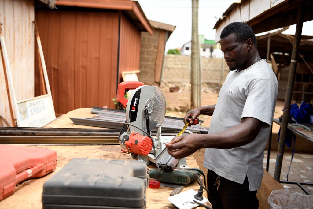 Solomon working at a workbench.