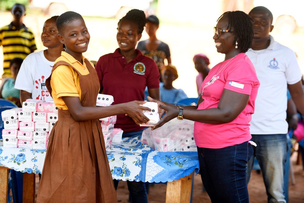 Girls receiving sanitary pads from Plan International Ghana