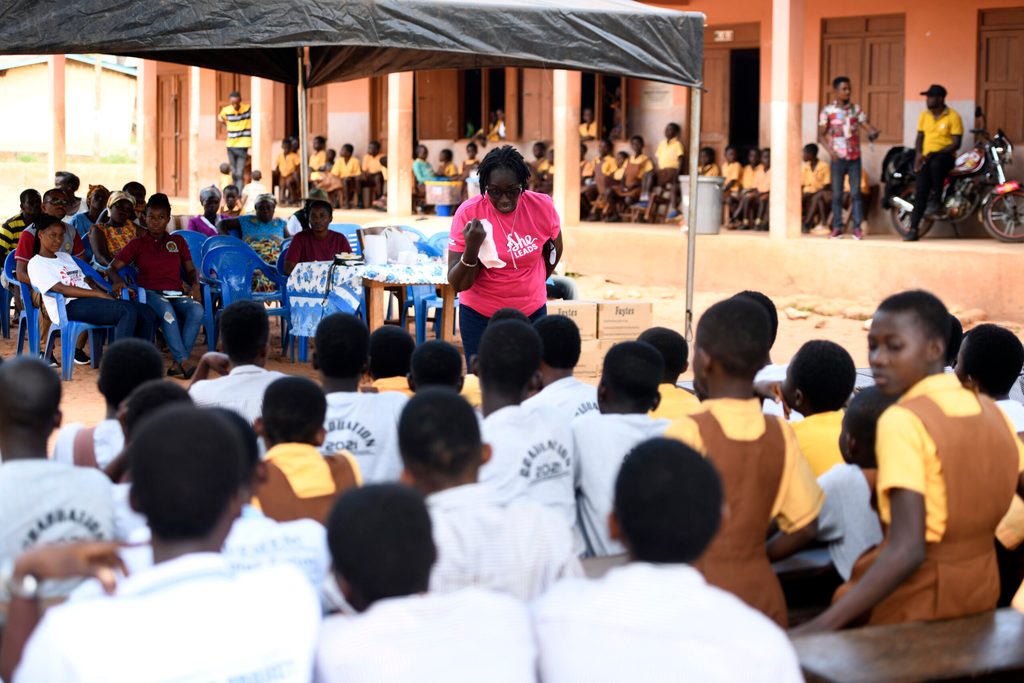 Girls receiving sanitary pads from Plan International Ghana