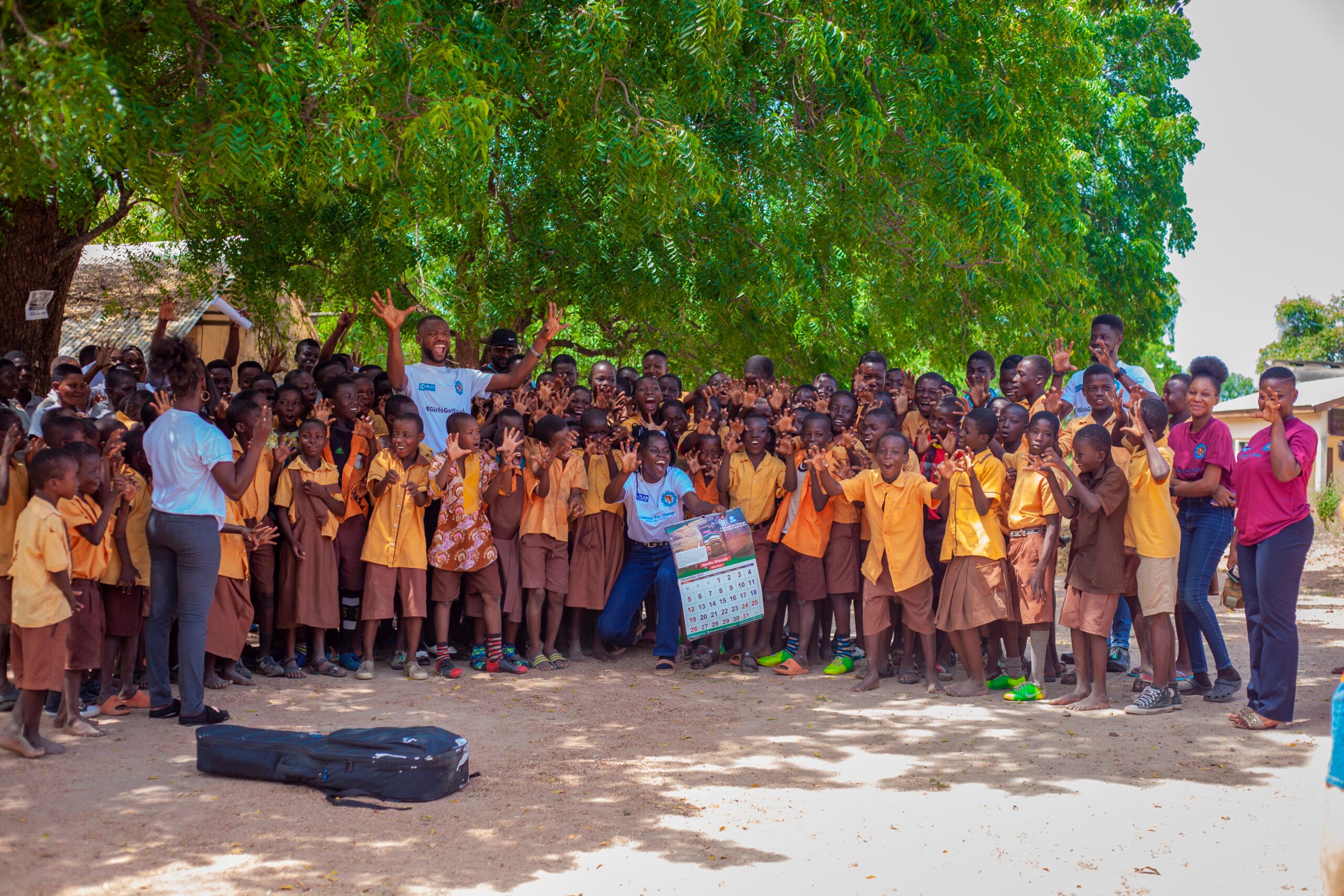 Students pose for a group picture with Wiyaala
