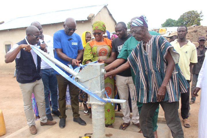 Community members opening a borehole