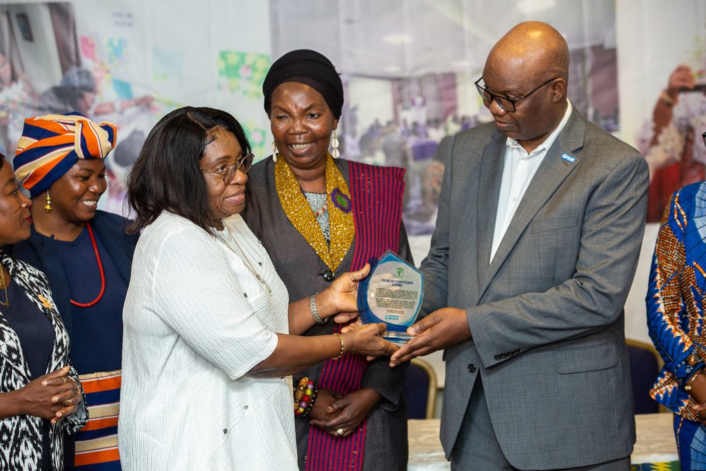 Country Director receiving an Award form WROs.