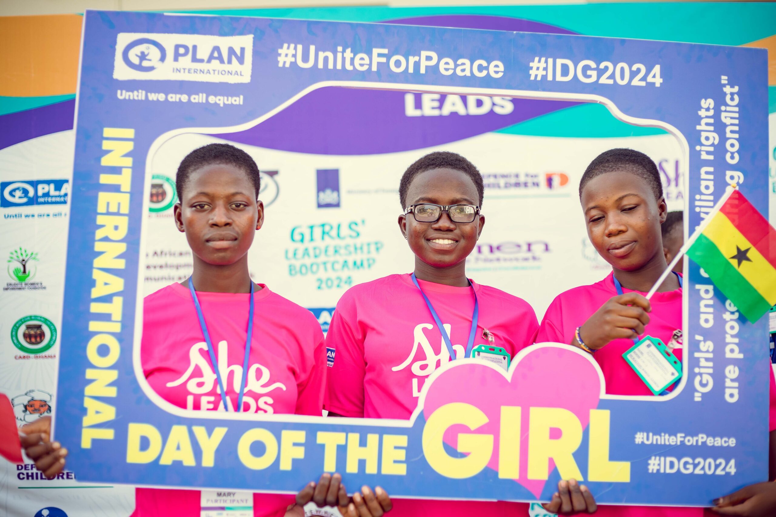 Young girls pose in a #uniteforpeace cutout. 