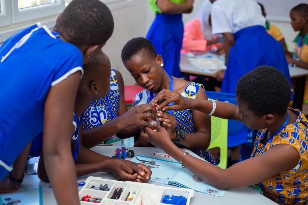 Girls building a robot.