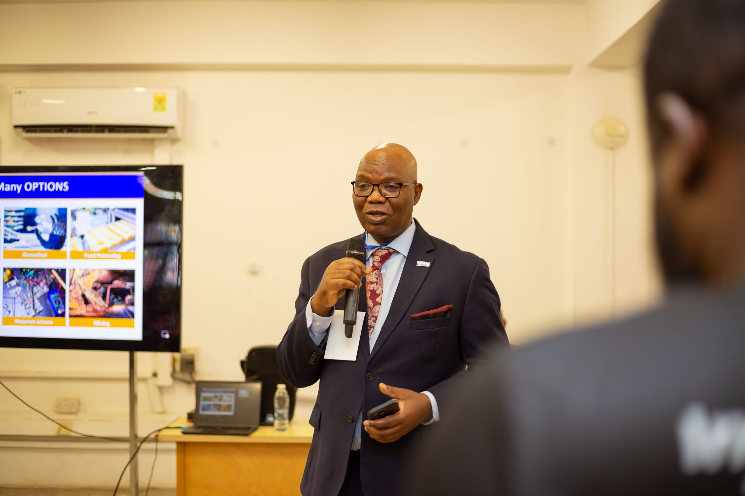 Country Director speaks into a microphone. 