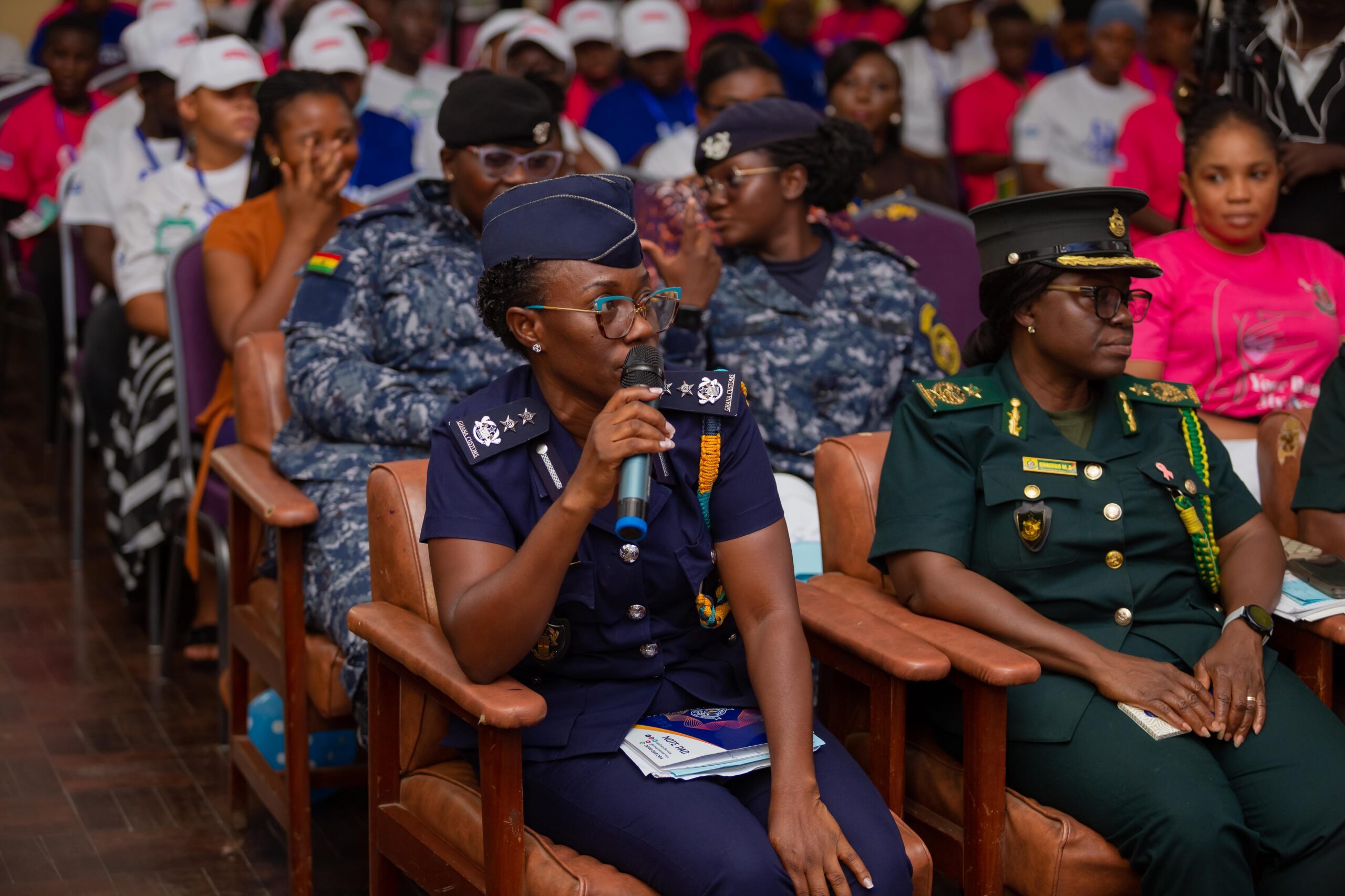 Officer from the Ghana Police service commending young children's efforts.