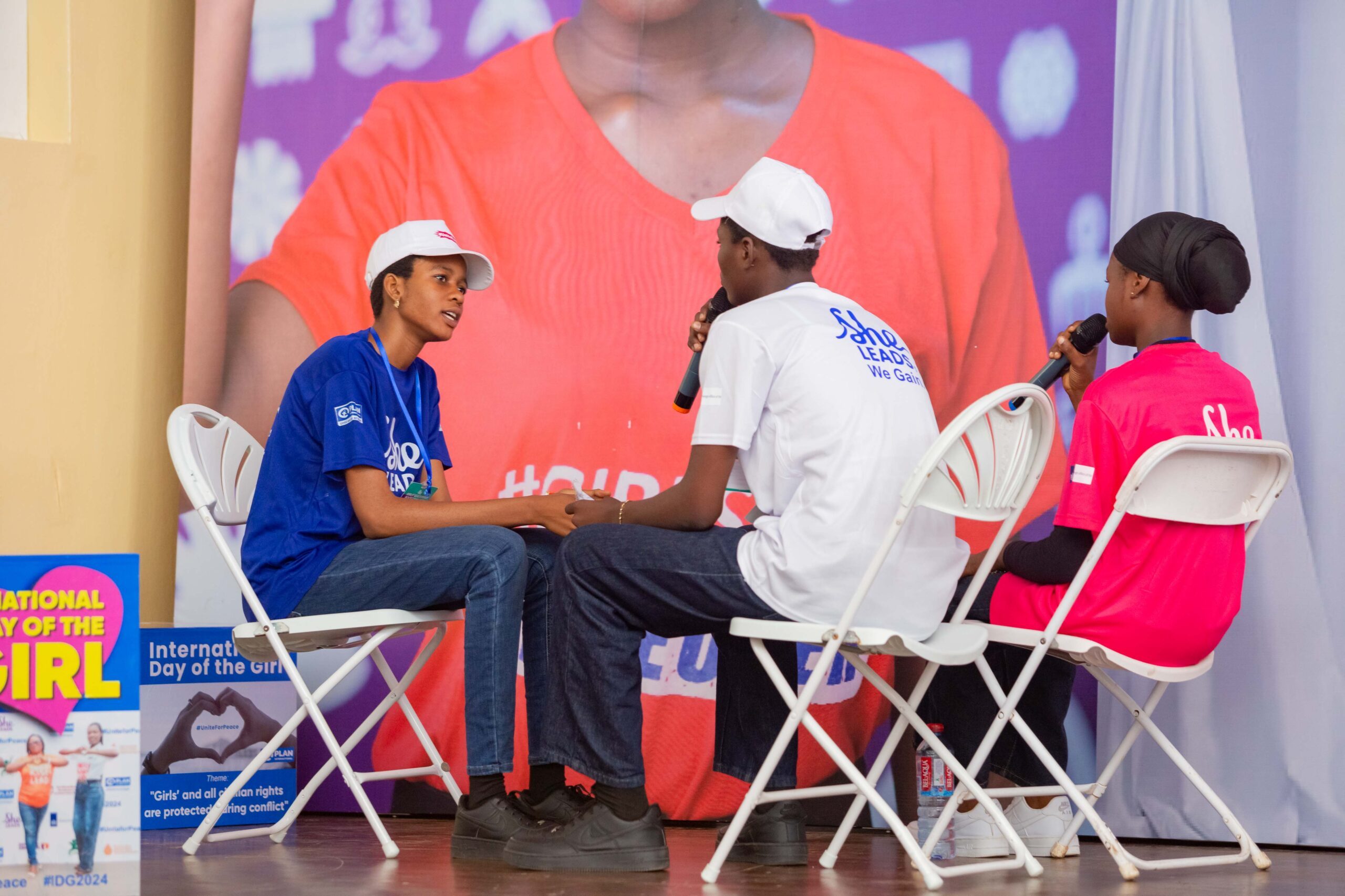 Young students perform on stage. 