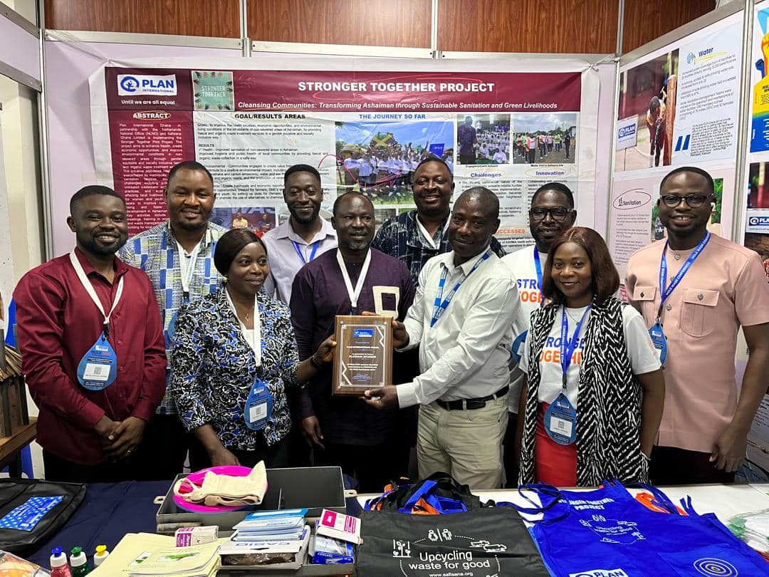 Stronger together Project and I-PADEV Project team pose for a photo at the exhibition booth