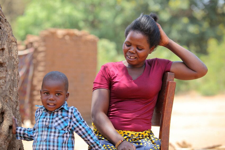 Modester with her young son.