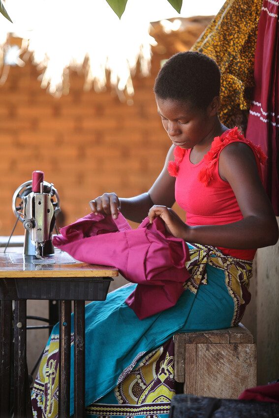 Rebecca working at her sewing machine.