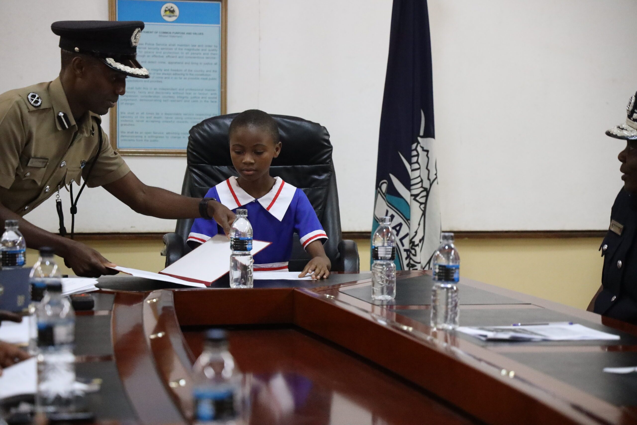 Chiyambi being briefed as the new police chief.