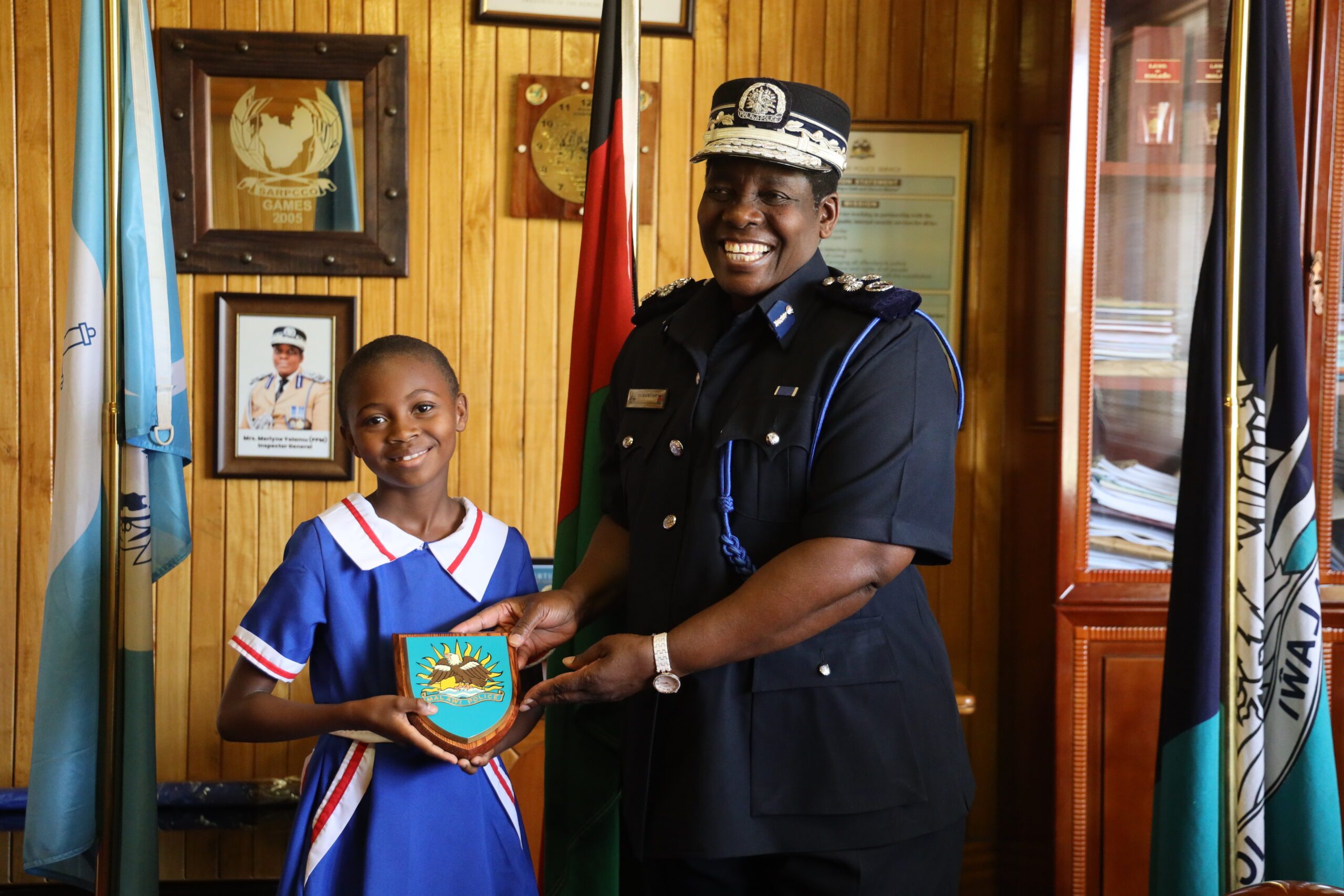 Chiyambi receives a Malawi Police Seal as a gift from the Inspector General.