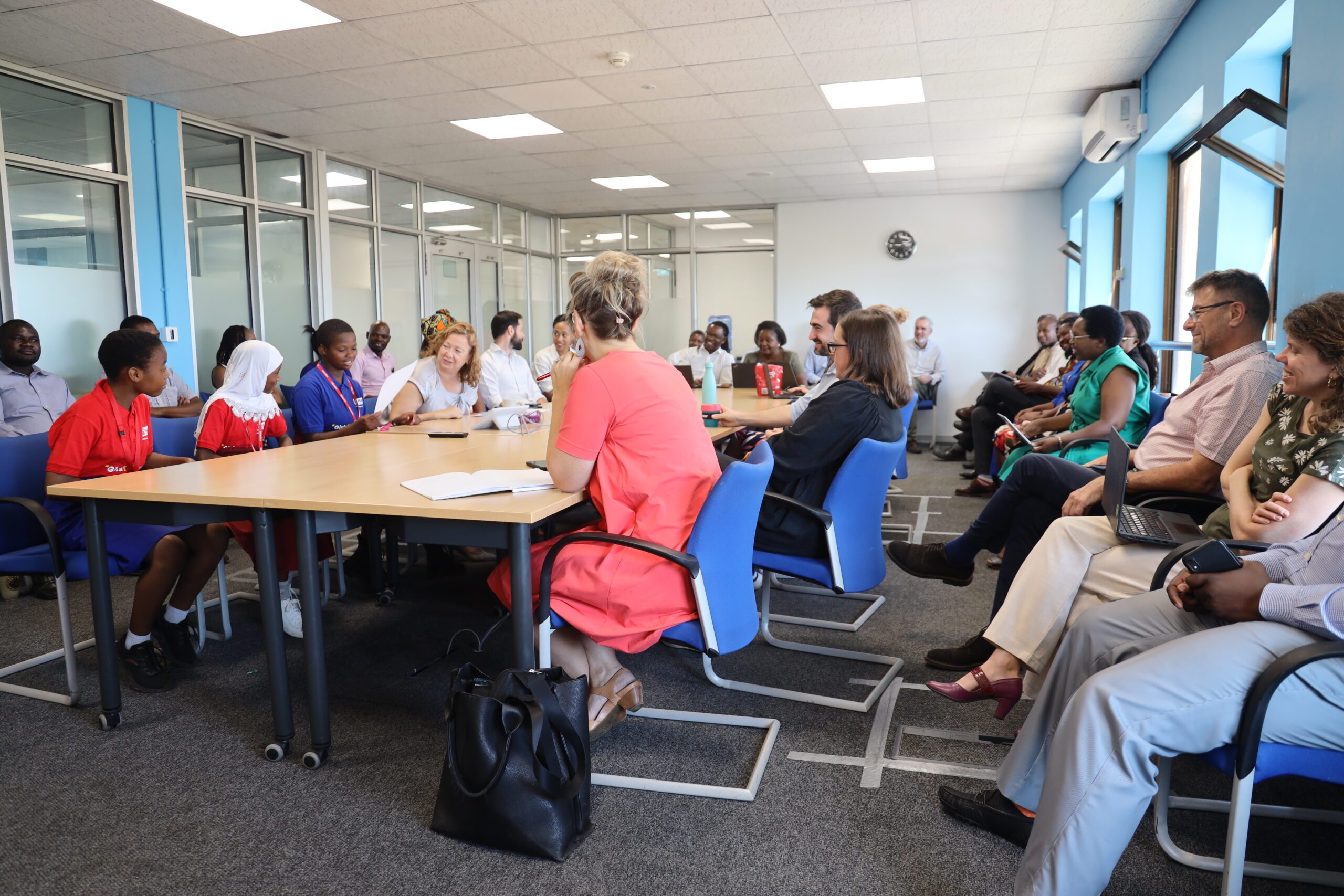 Harriet, Frankline and Fatuma presiding over a staff meeting