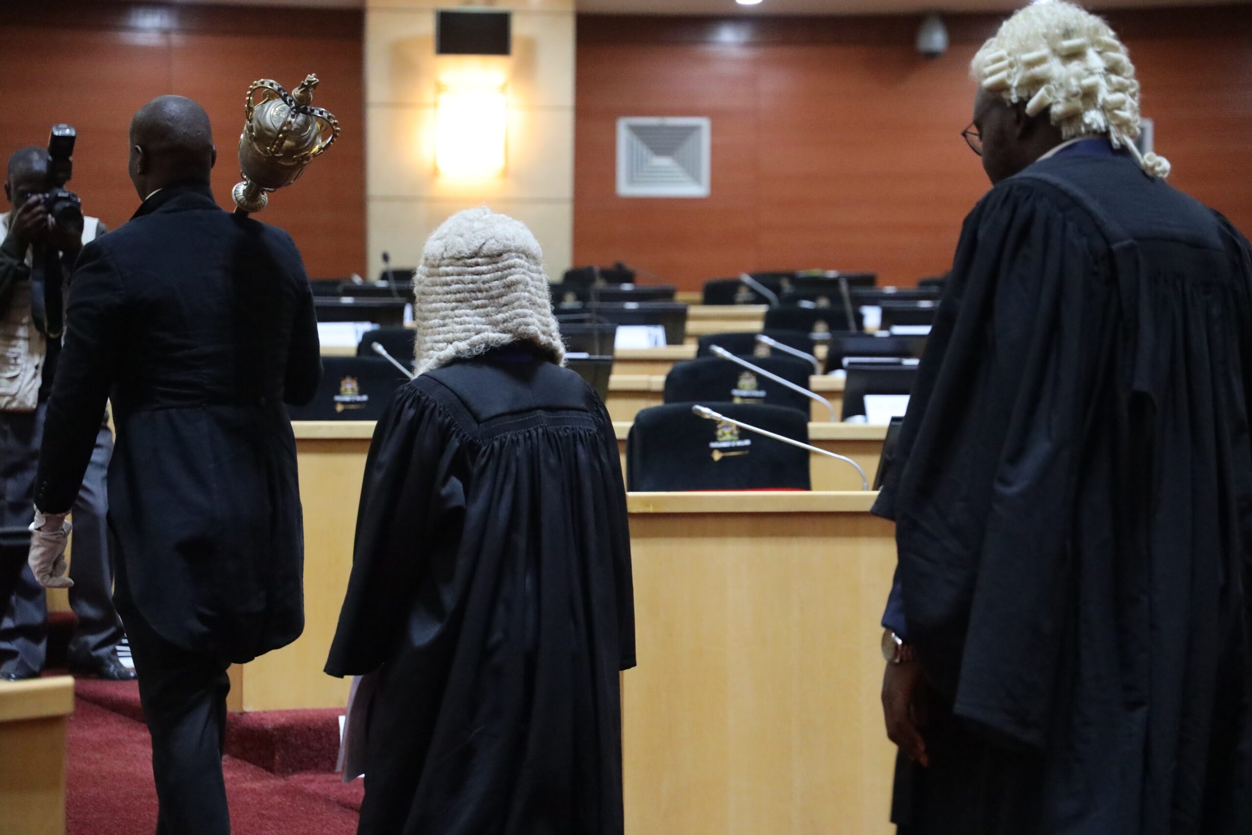 The sergeant-at-arms escorts Marveille who was taking over the Speaker of Parliament role