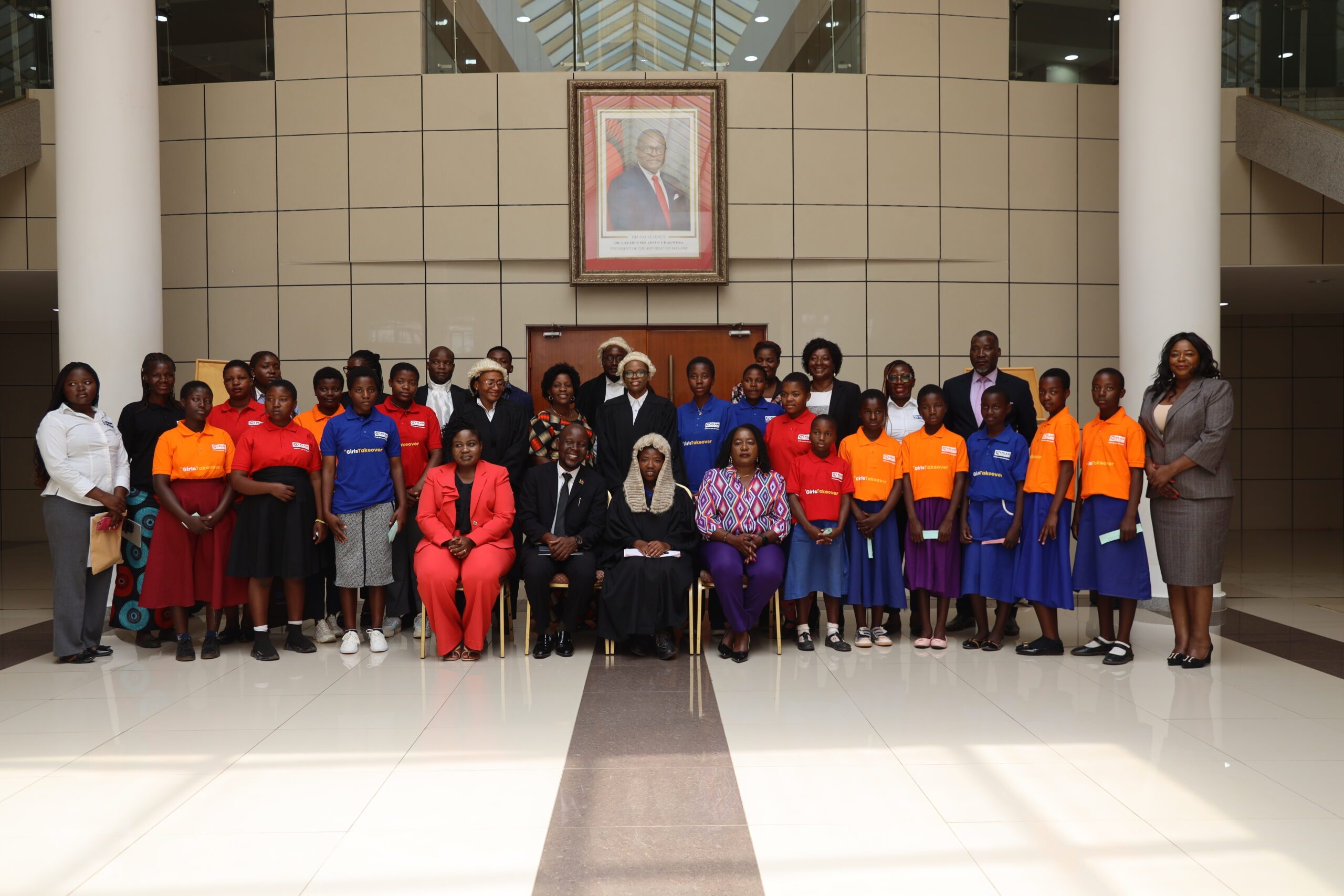 Girls pose with some members of Parliamentary Committees and Parliament table clerks