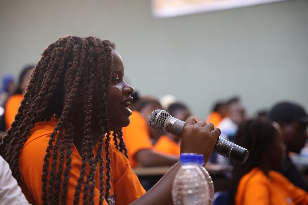 A student speaks into a microphone.