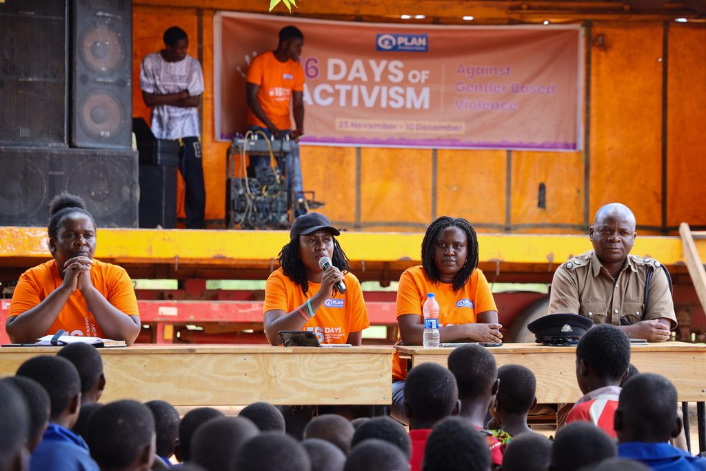 Panelists sit and speak into microphones.