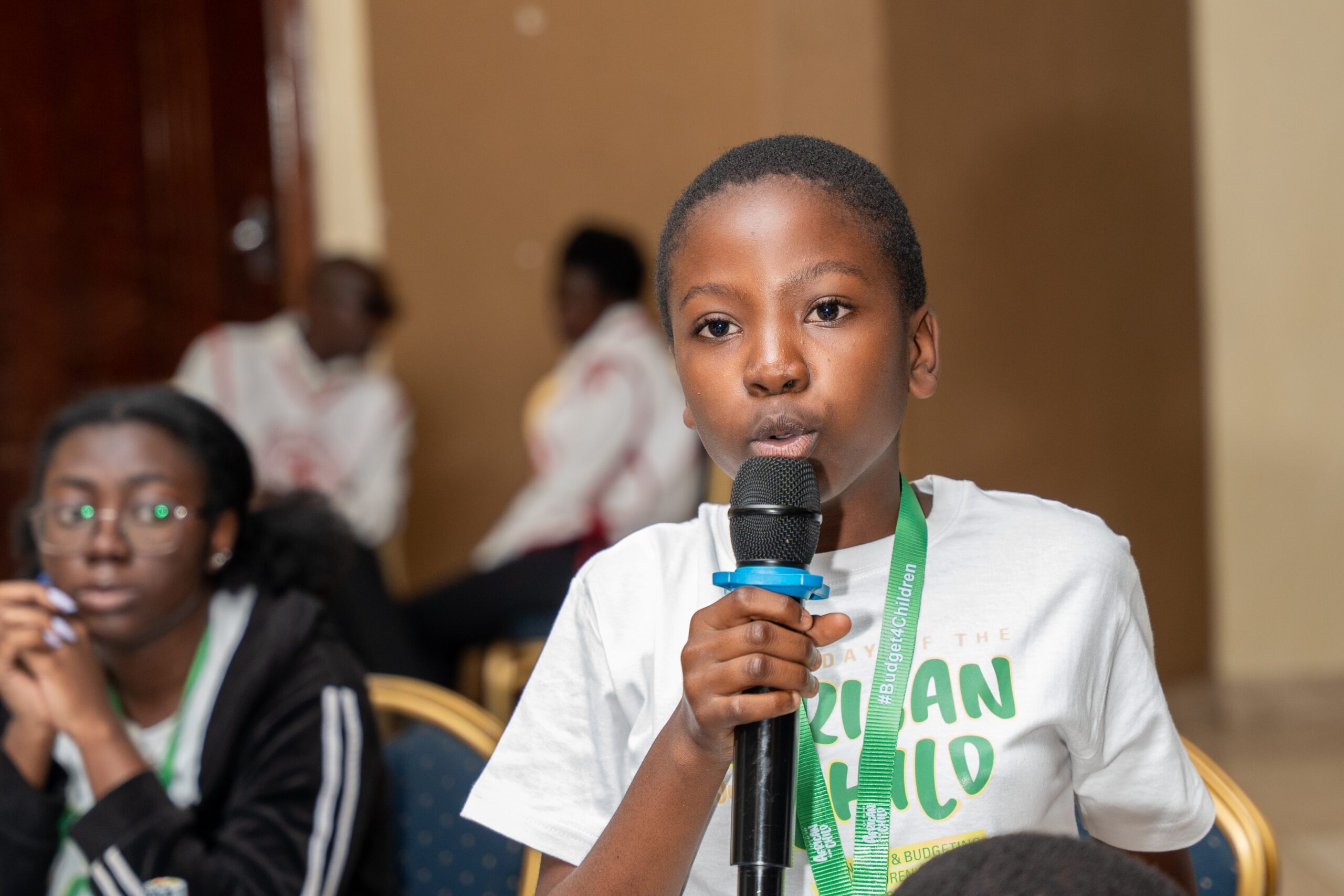 A child speaking into a microphone.