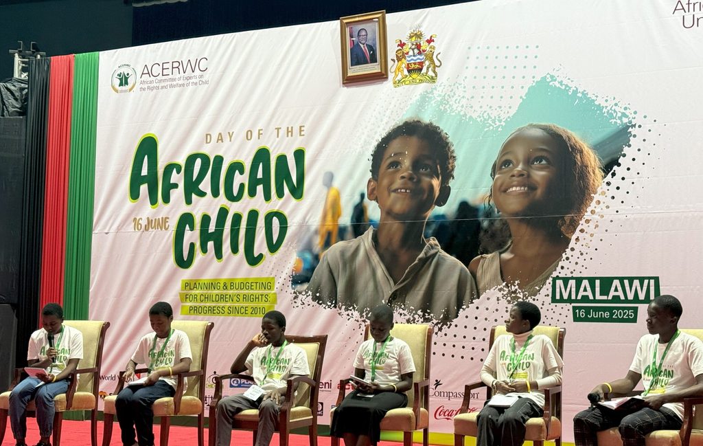 A panel of speakers on stage at the event.