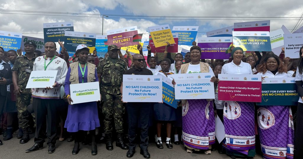 Plan Malawi holding up banners and meaningfully participating in the commemoration.