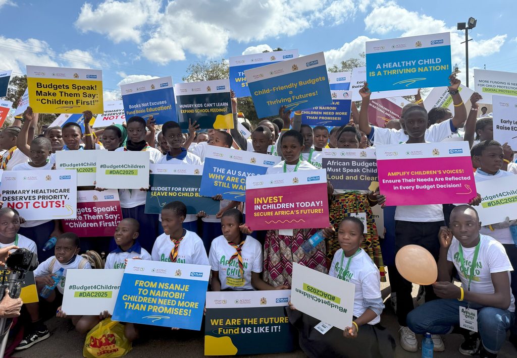A group of young people holding up banners and posters.