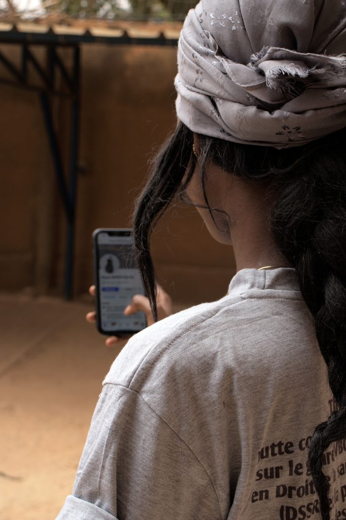 Aichatou using her mobile phone