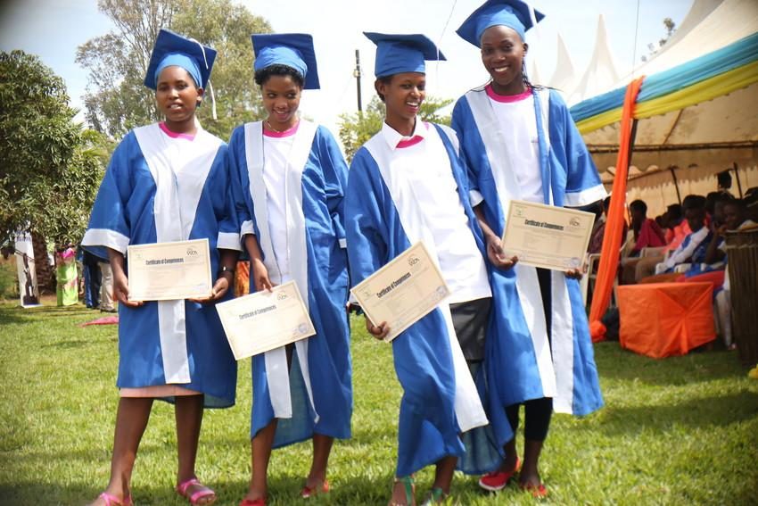 Girls pose with their certificates at graduation ceremony in Gatisbo district