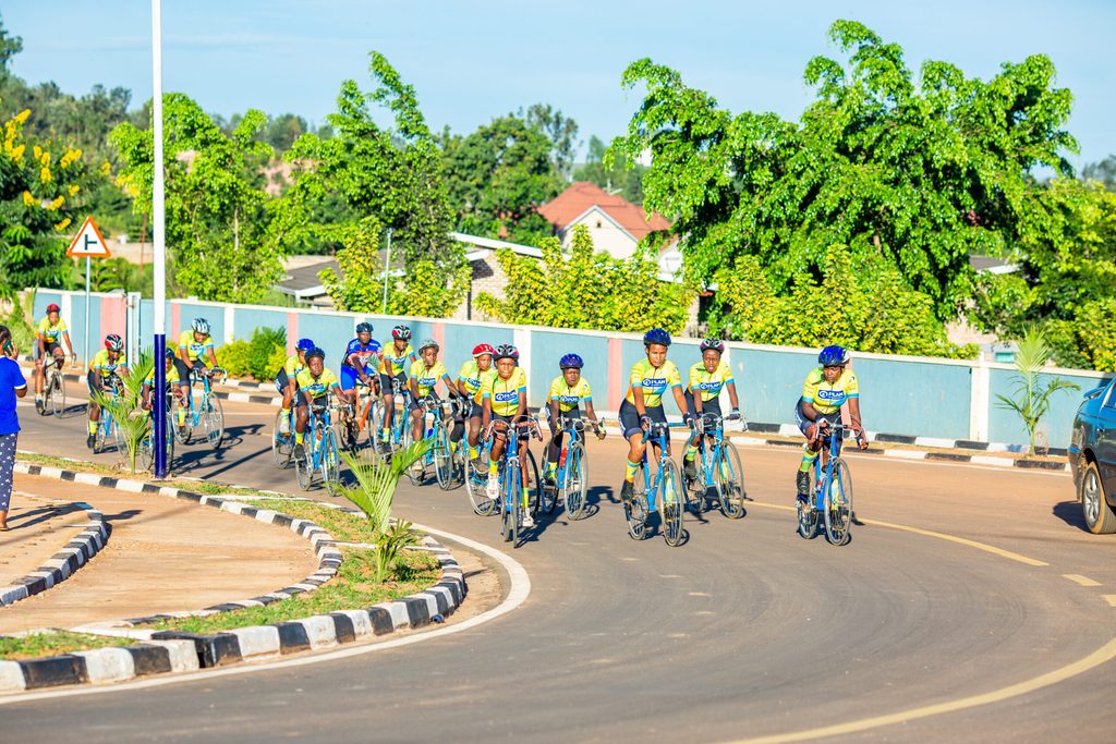 Olivia and her teammates cycling on the road during practice.