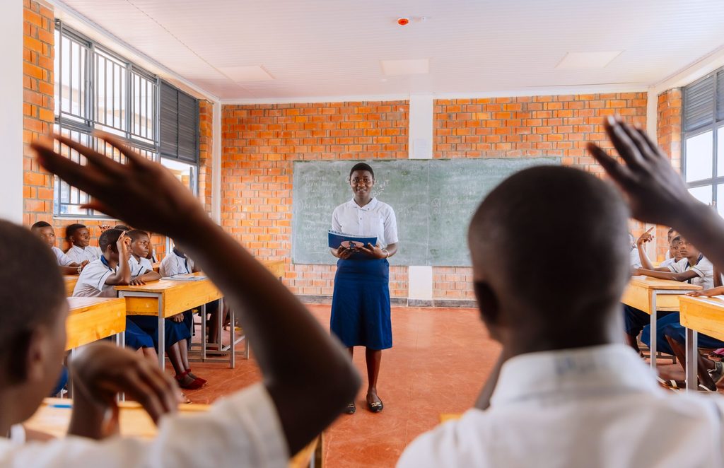 Esther stands in front of the school club and hosts an education session.