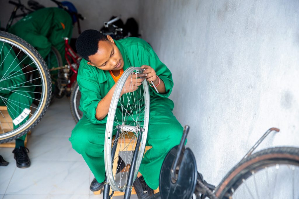 Joyce mending a bike.