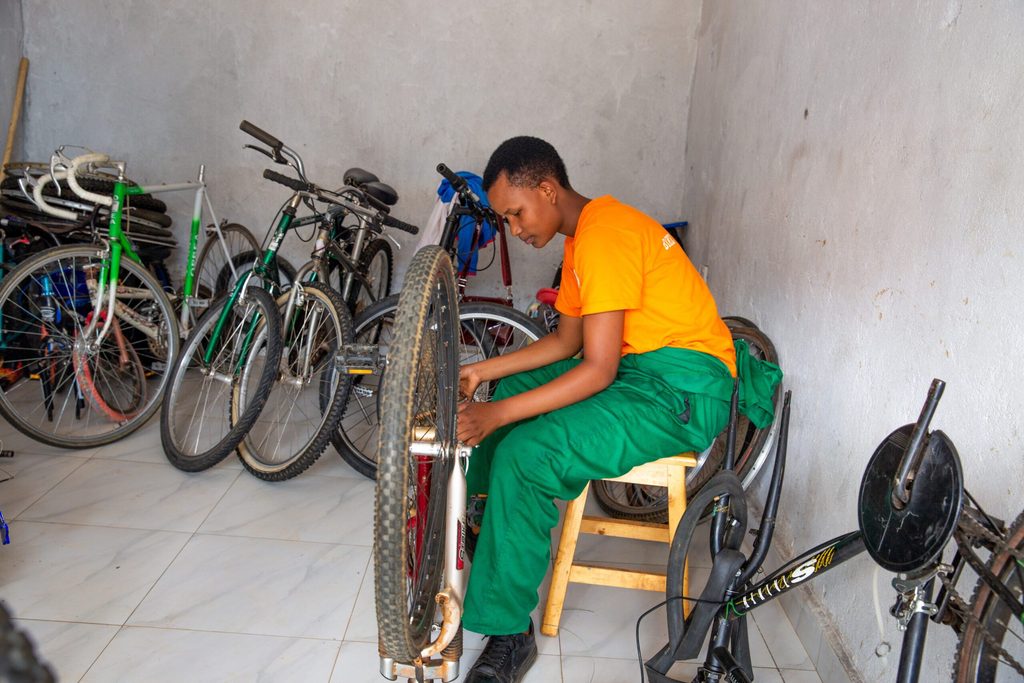 Olivia mending a bike.