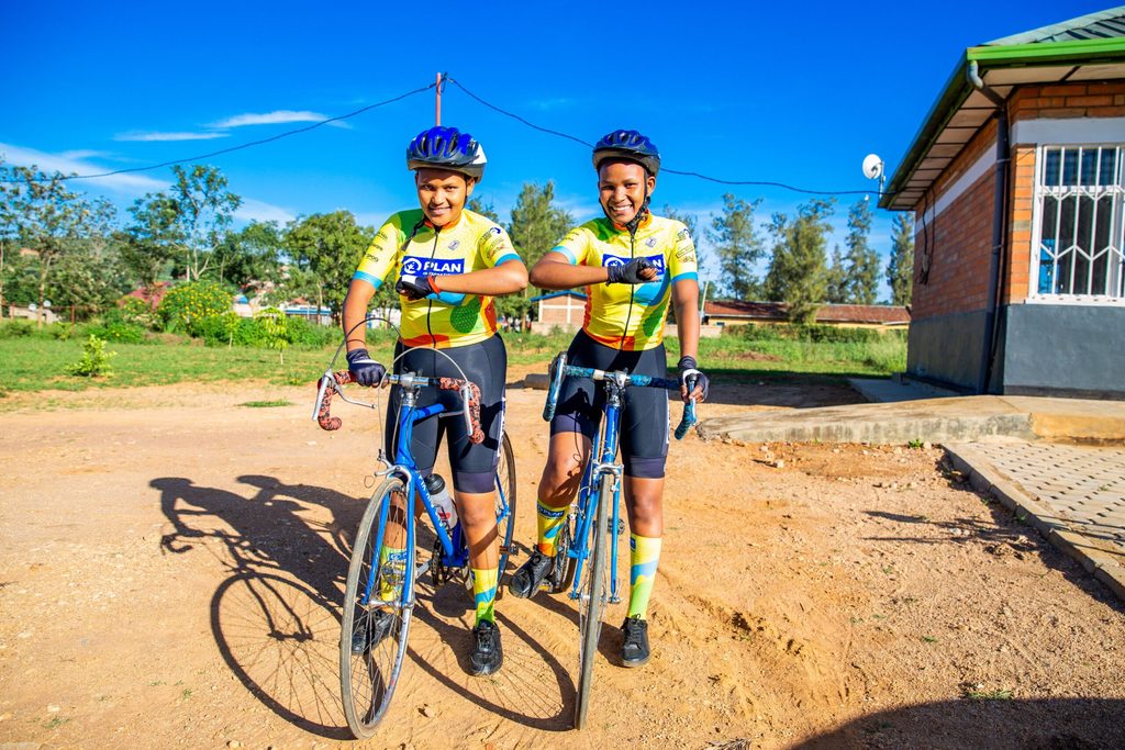 Joyce and Olivia pose on their bikes dressed for a cycling session.