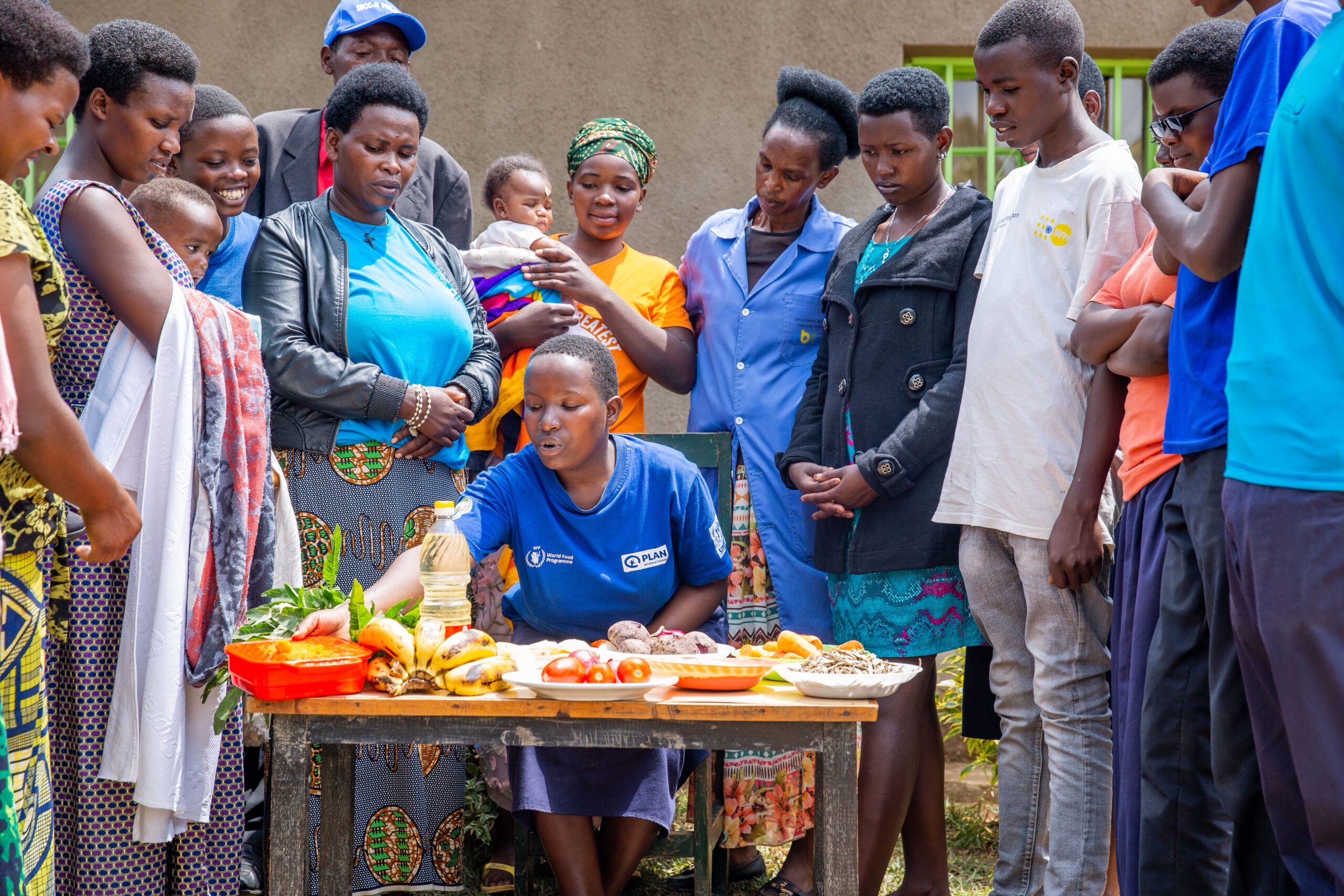 Participants at the community cooking demonstration learn how to prepare a balanced diet.