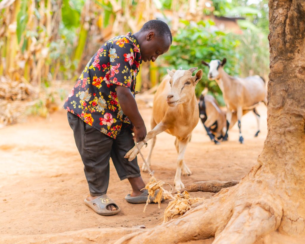 Emmanuel with one of his goats.