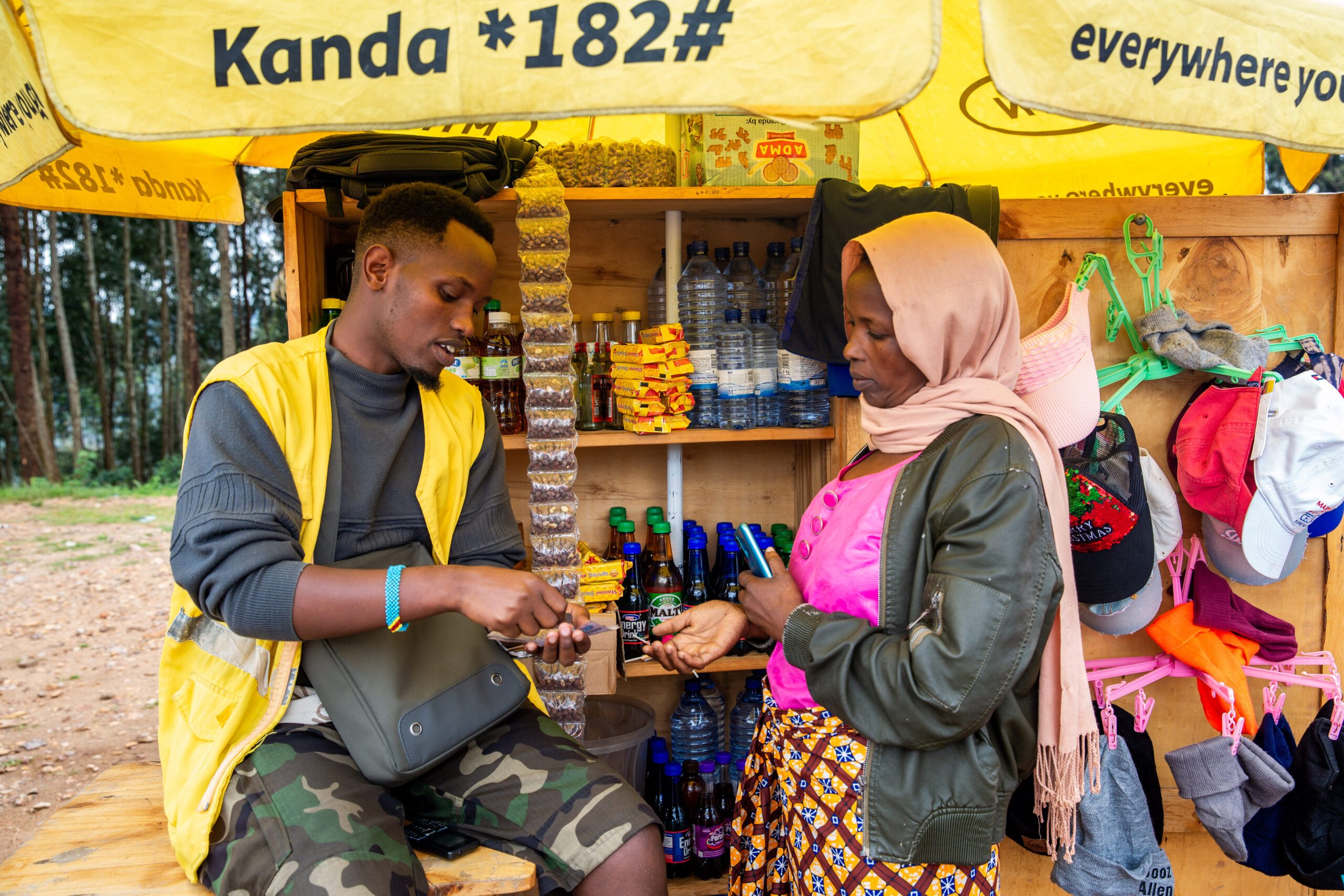 Eric serves a client at his mobile money business.