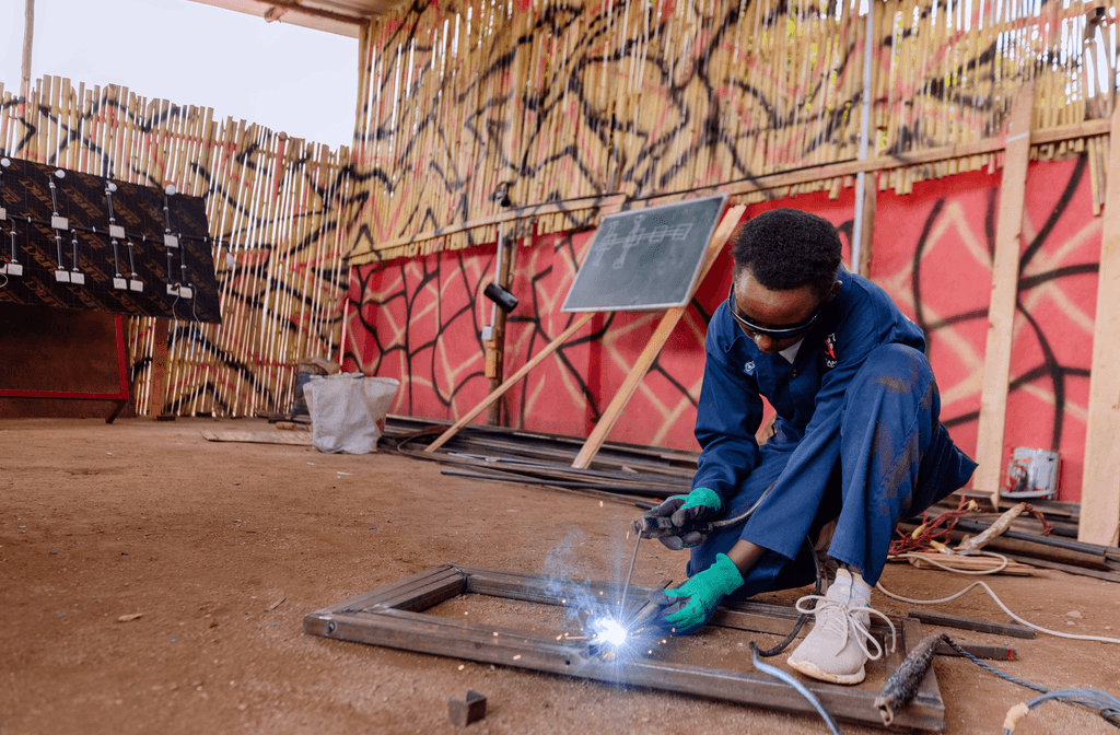 Yassin taking part in a hands-on welding session.