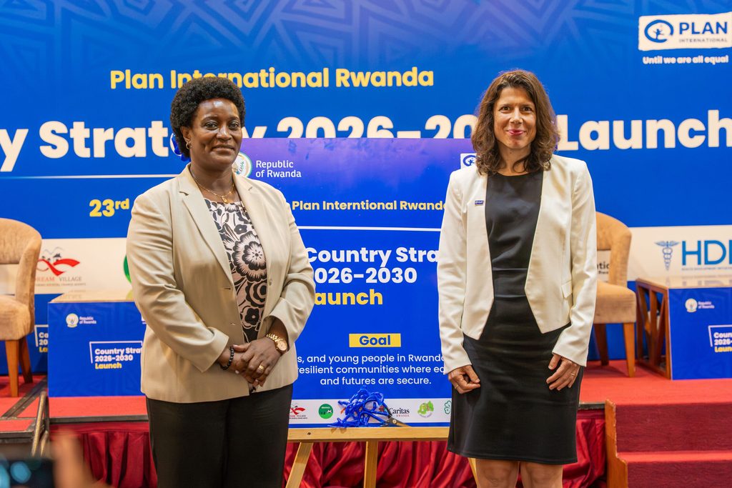 Minister and Country Director unveiling Plan International Rwanda’s new Country Strategy 2026–2030.