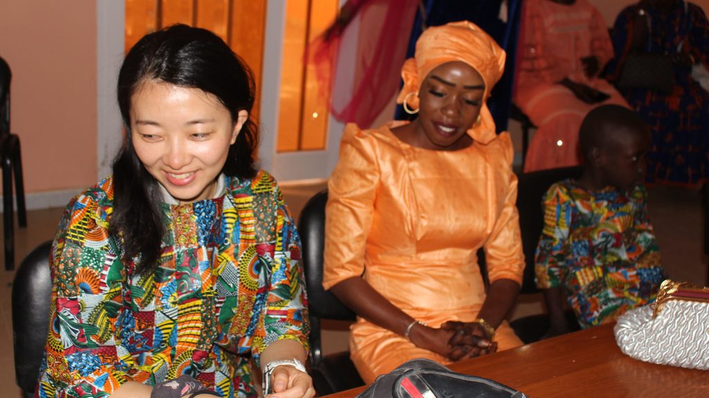 Ai Tanaka, Awa and Moussa sit together.