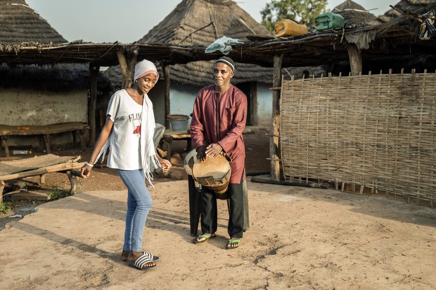 Fatou dances to the beat of her father's drum. 