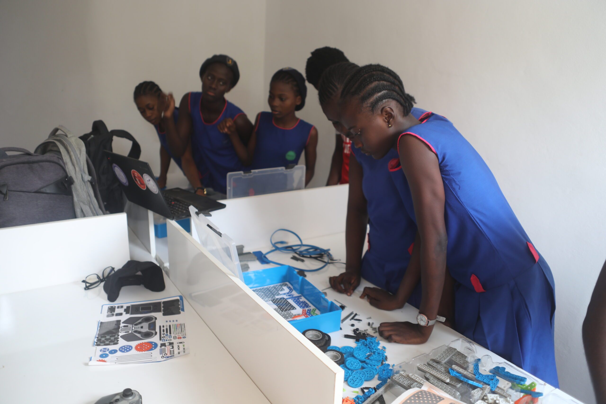 Girls at a robotics club building a robot at the Kamara Yokie Innovation Centre