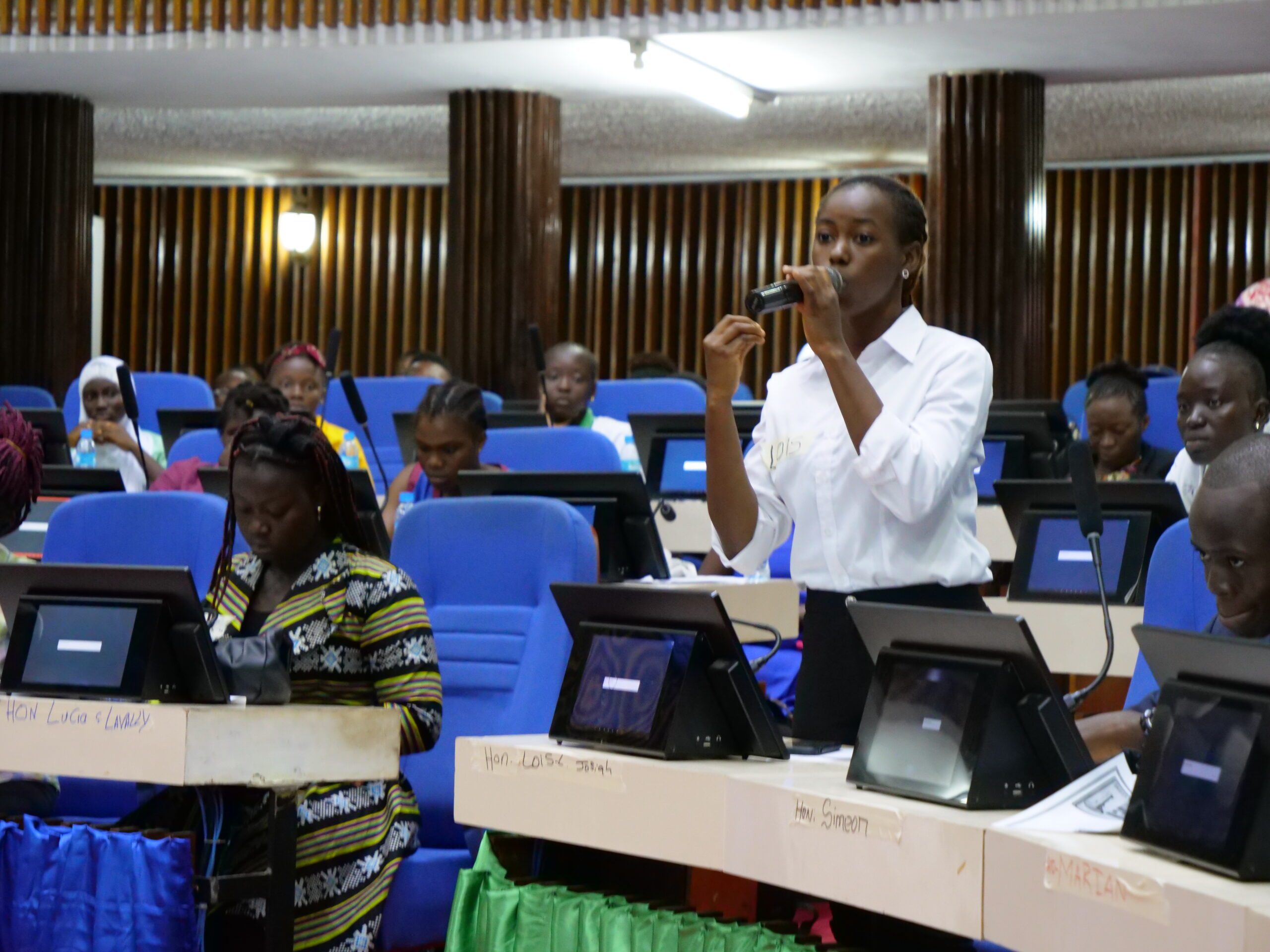 Lois, a young women speaking up during the debate in parliament.