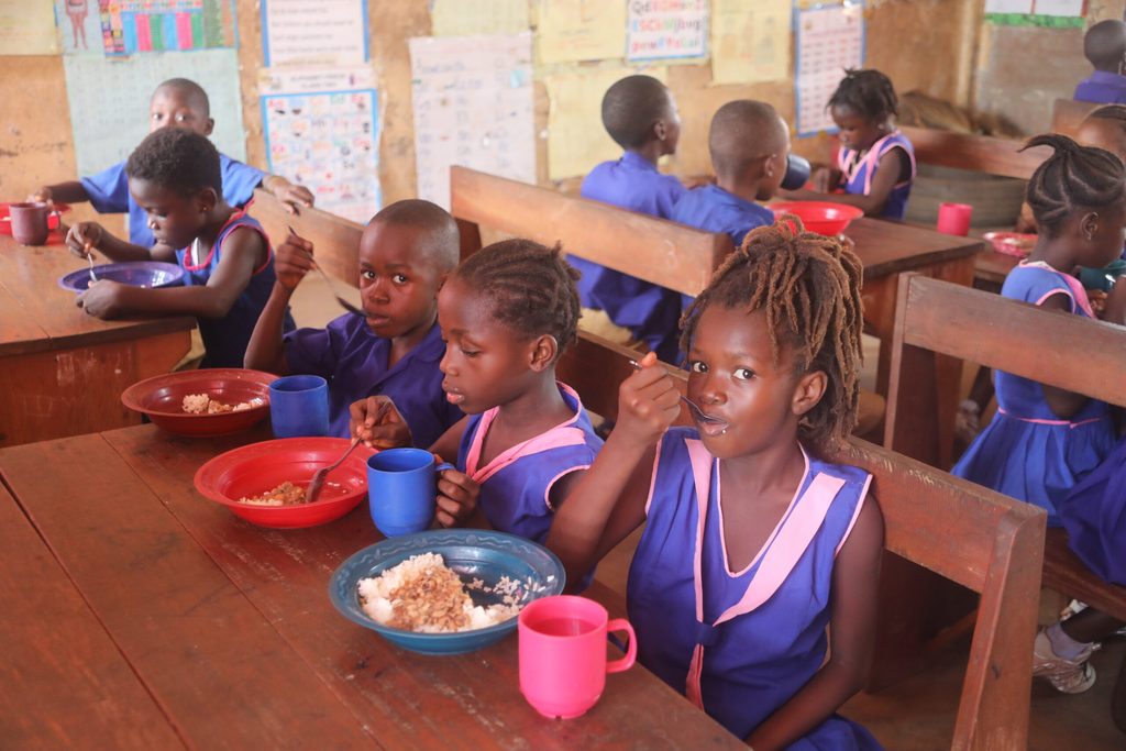 Isha eating a meal in a classroom at school