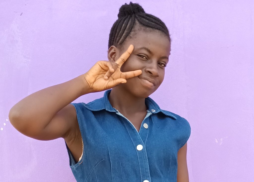 Girl showing Girls Get Equal sign