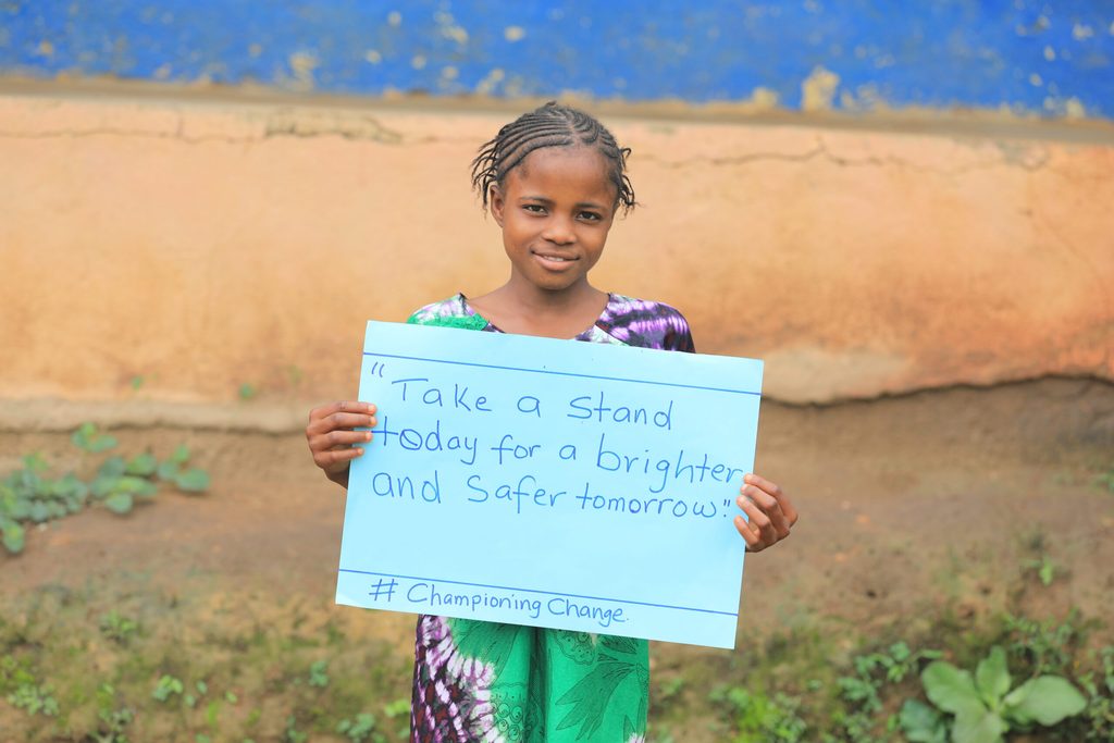 Girl holding up a champion of change sign
