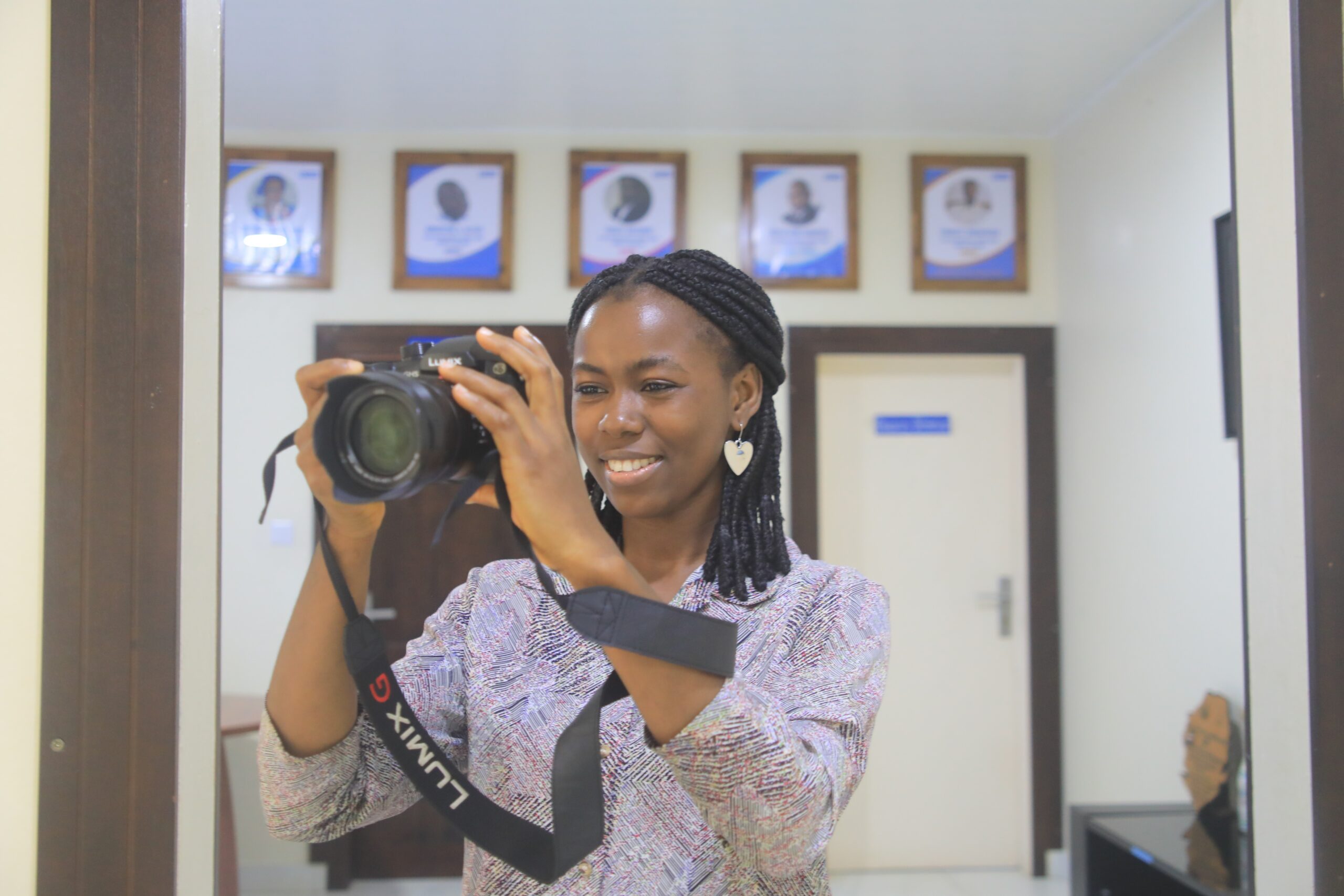 Lois taking pictures in the office.