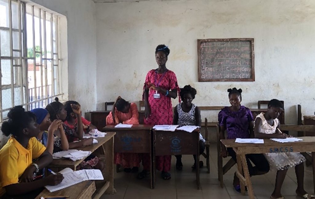 Young woman speaking in class.